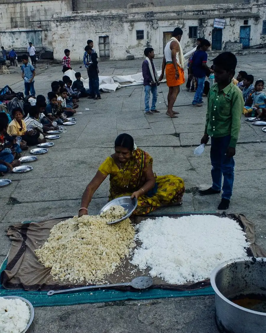 Children seated in rows for a community meal